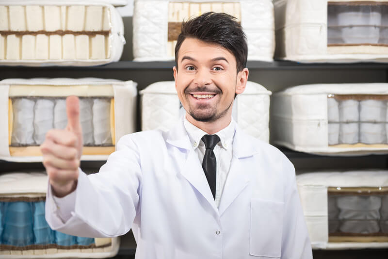 a person with commercial grad mattress materials behind him.