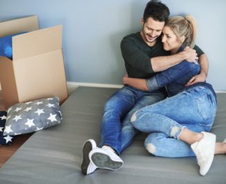 A couple laying on a full size mattress. What happened to the full size bed?
