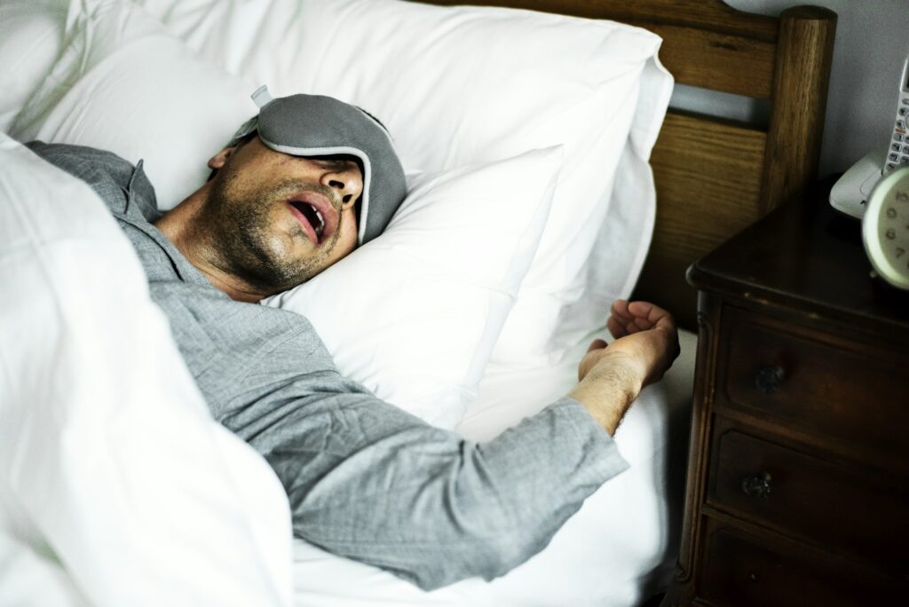 A man sleeping on a bed.